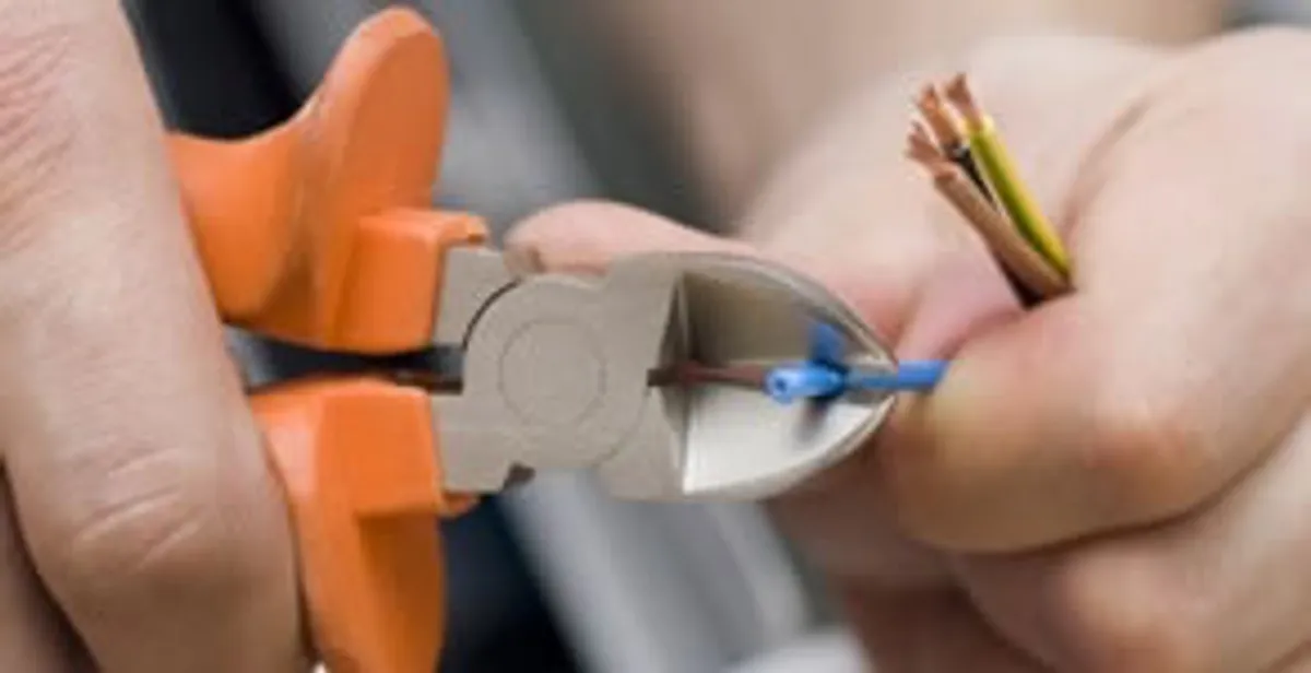 professional electrical services showing precise wire cutting by licensed electricians in Arlington, TX